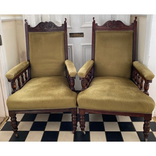 80 - A pair of Edwardian stained beech upholstered armchairs on casters 107 h to back to chair 42cm h to ... 