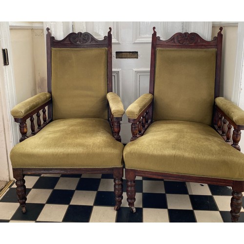 80 - A pair of Edwardian stained beech upholstered armchairs on casters 107 h to back to chair 42cm h to ... 