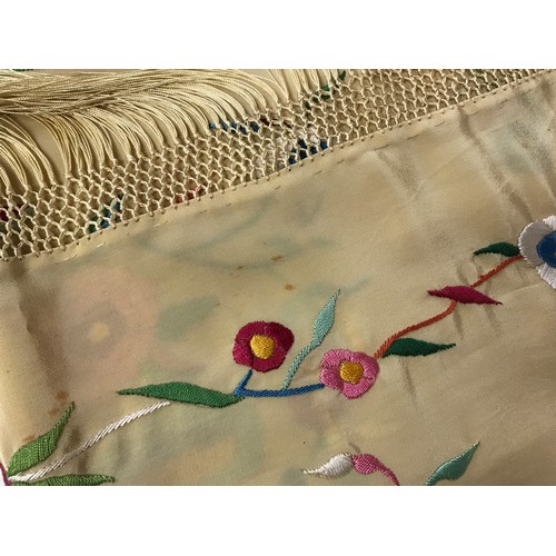 918 - A mid 20thC cream silk embroidered shawl, decorated with flowers, knotted fringe, approx. 165 x 55cm... 