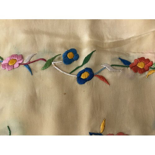 918 - A mid 20thC cream silk embroidered shawl, decorated with flowers, knotted fringe, approx. 165 x 55cm... 