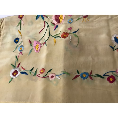 918 - A mid 20thC cream silk embroidered shawl, decorated with flowers, knotted fringe, approx. 165 x 55cm... 