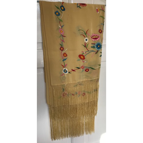 918 - A mid 20thC cream silk embroidered shawl, decorated with flowers, knotted fringe, approx. 165 x 55cm... 