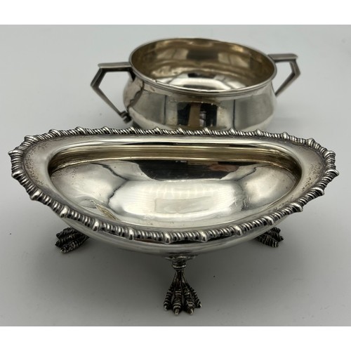 722 - Silver to include a twin handled bowl, Birmingham 1932, makers marks rubbed and a dish raised on fou... 