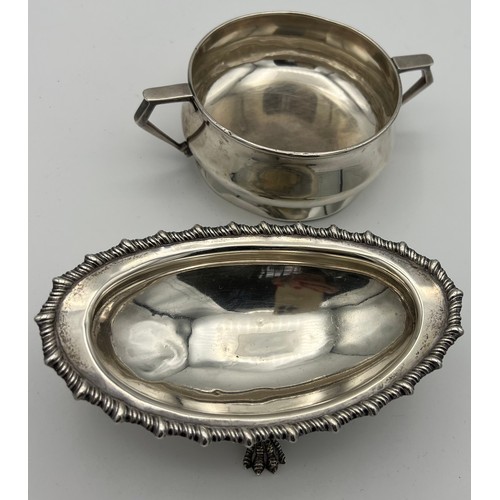 722 - Silver to include a twin handled bowl, Birmingham 1932, makers marks rubbed and a dish raised on fou... 