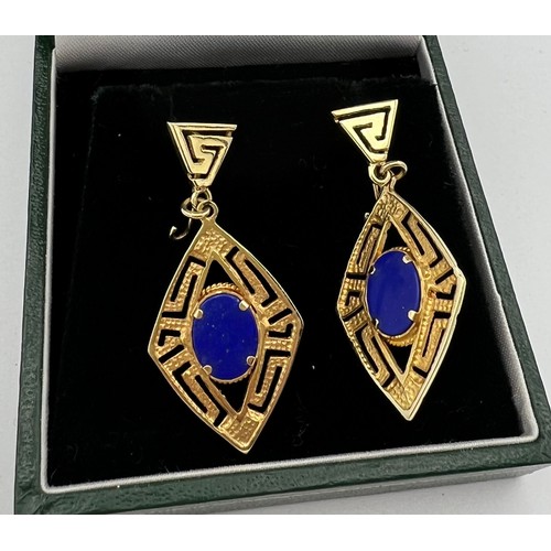 553 - Yellow metal drop earrings set with Lapis Lazuli. Tests as 14 carat. 4cm drop.