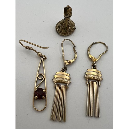 554 - Yellow metal to include a pair of earrings, single earring and a watch fob. Tests as 9 carat gold. T... 