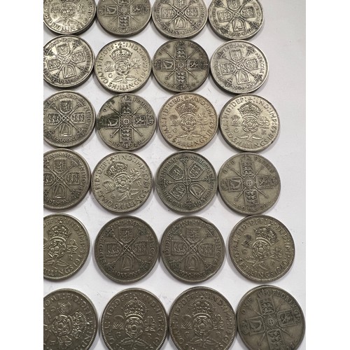 643 - A collection of pre 1946 One Florin and Two Shilling coins. 537.5gm.