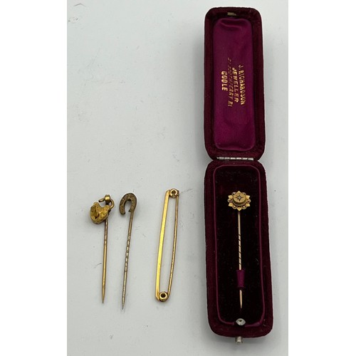 562 - A 9ct gold tie pin and 9ct gold bar brooch in fitted cases together with two unmarked tie pins. Weig... 