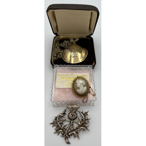 558 - Silver oyster shell pendant, white metal thistle brooch and a cameo brooch.