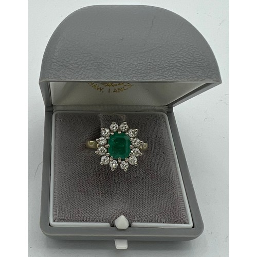 559 - An emerald and diamond cluster ring set in 18 carat yellow gold. Size N, weight 6.9gm. Emerald appro... 