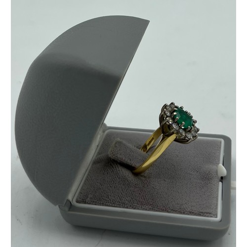 559 - An emerald and diamond cluster ring set in 18 carat yellow gold. Size N, weight 6.9gm. Emerald appro... 