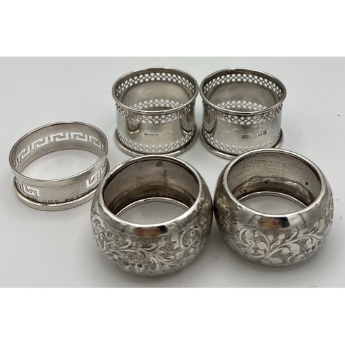 723 - Five hallmarked silver napkin rings, various dates and makers. Total weight 90gm.