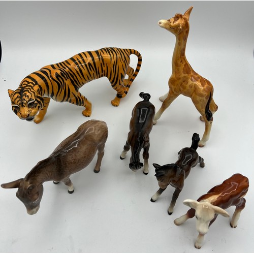 338 - Six various Beswick animals to include Tiger, Donkey, Giraffe and others.
