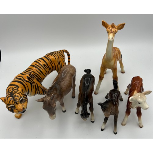 338 - Six various Beswick animals to include Tiger, Donkey, Giraffe and others.