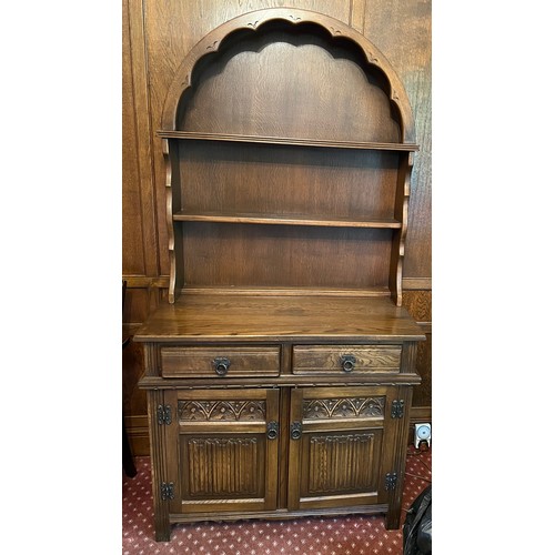 91 - Oak dresser, two drawers over two cupboards with arched topped rack to back. 93 x 44 x 182cm h.