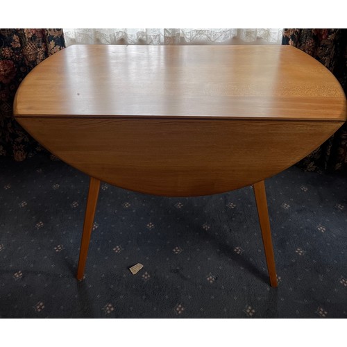 93 - A drop leaf Ercol dining table, 124 x 113cm extended.