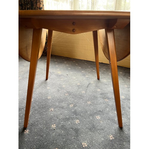 93 - A drop leaf Ercol dining table, 124 x 113cm extended.