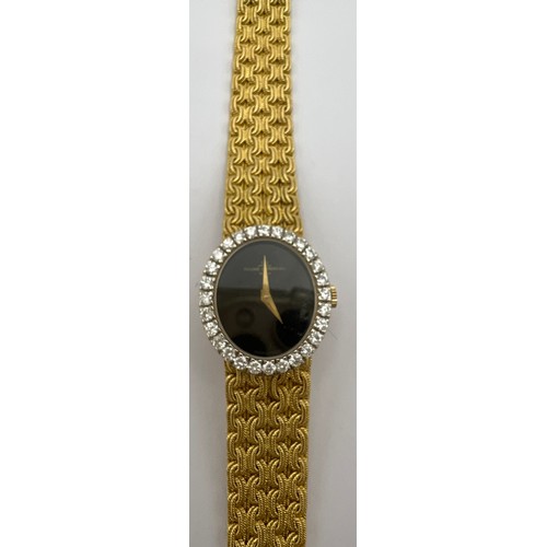 985 - An 18 carat Baume and Mercier lady's wristwatch with diamond bezel, black oval face on an 18 carat g... 