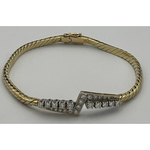 573 - A 14 carat gold bracelet set with diamonds. Marked .585. Weight 14.8gm.