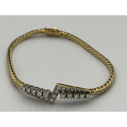 573 - A 14 carat gold bracelet set with diamonds. Marked .585. Weight 14.8gm.