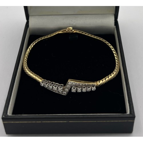 573 - A 14 carat gold bracelet set with diamonds. Marked .585. Weight 14.8gm.