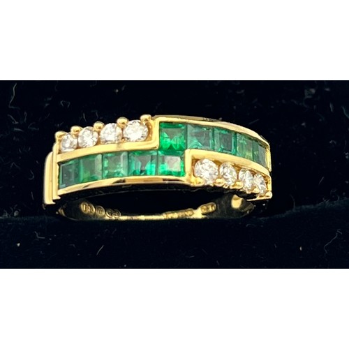 576 - An eighteen carat gold ring set with diamonds and emeralds. Size M. Weight 3.9gm.