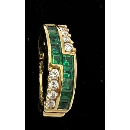 576 - An eighteen carat gold ring set with diamonds and emeralds. Size M. Weight 3.9gm.