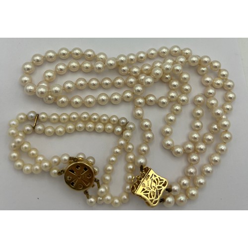 579 - Cultured pearl double strand necklace with 18 carat pearl and diamond set clasp and a double strand ... 