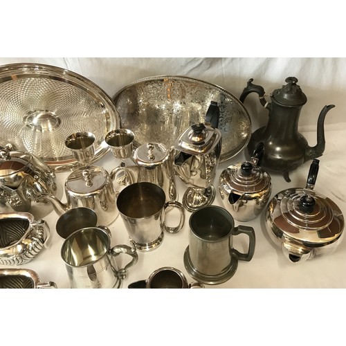 691 - A large collection of silverplate and pewter items to include three trays, kettles, coffee pots, cup... 