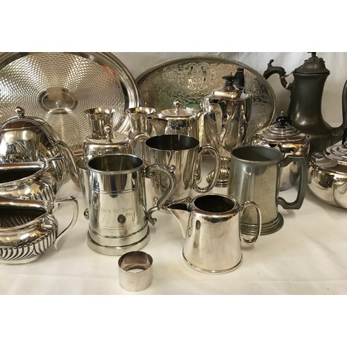 691 - A large collection of silverplate and pewter items to include three trays, kettles, coffee pots, cup... 