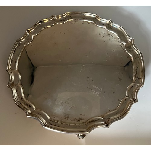 736 - A silver tray raised on scroll feet. Weight 458gm.  25cm d. Sheffield 1960 maker William Bush and so... 