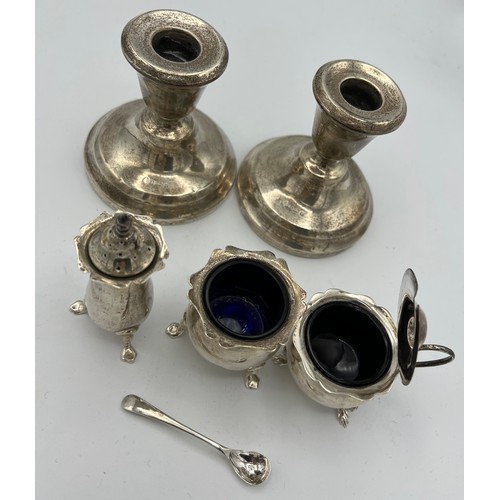 737 - Silver to include three-piece cruet, mustard spoon and a pair of candlesticks with weighted bases, B... 