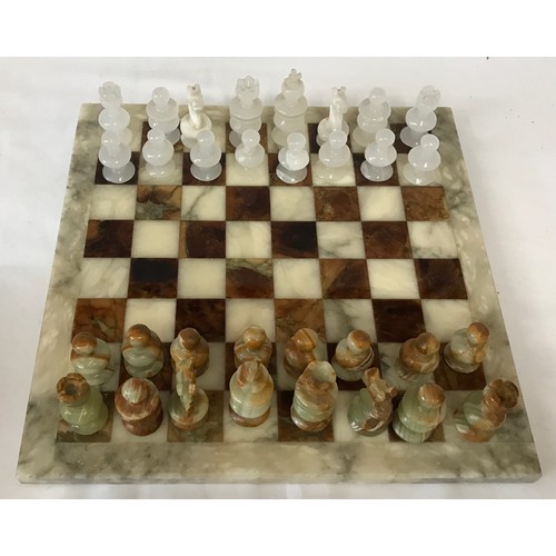 829 - Onyx chess board and pieces, board 36cm square, King 7cm h. Pieces in a Simmers Biscuit Tin.