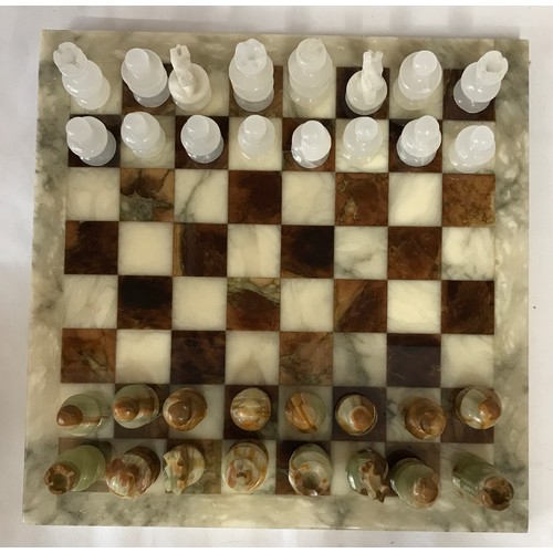 829 - Onyx chess board and pieces, board 36cm square, King 7cm h. Pieces in a Simmers Biscuit Tin.