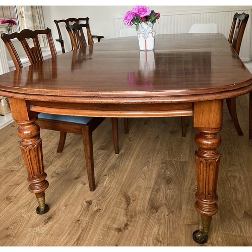 85 - A 19thC mahogany wind out dining table on fluted tapering legs and brass castors. 76 h x 121 w x 148... 