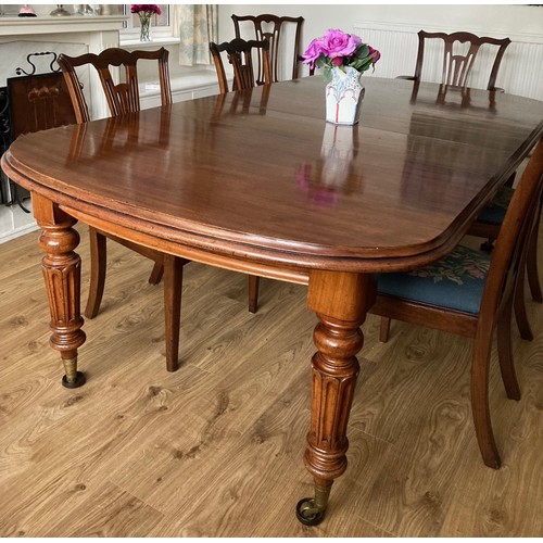 85 - A 19thC mahogany wind out dining table on fluted tapering legs and brass castors. 76 h x 121 w x 148... 