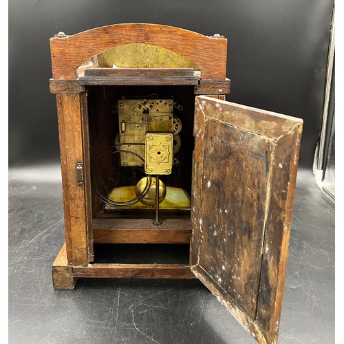 1192 - An Arts and Crafts oak and brass mantle clock. Probably Liberty. 37h x 25 w.