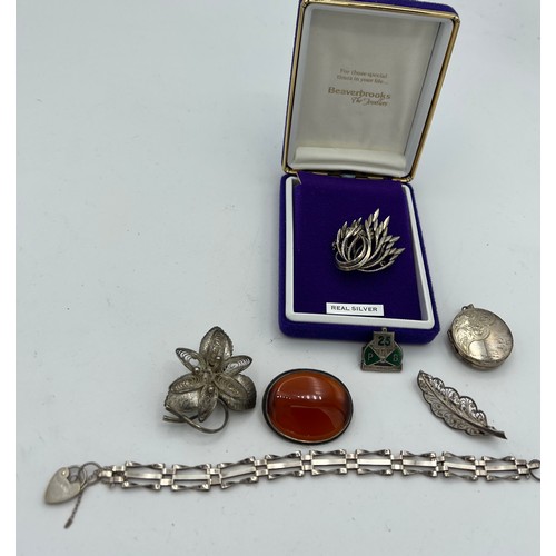 567 - Assorted silver to include four brooches, locket, bracelet, pin with 