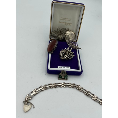 567 - Assorted silver to include four brooches, locket, bracelet, pin with 