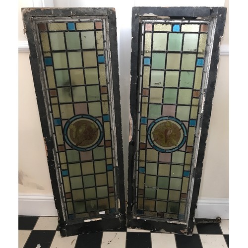 405 - A pair of stained-glass panels depicting a bird to the central pane. Full size 127 x 42cm.