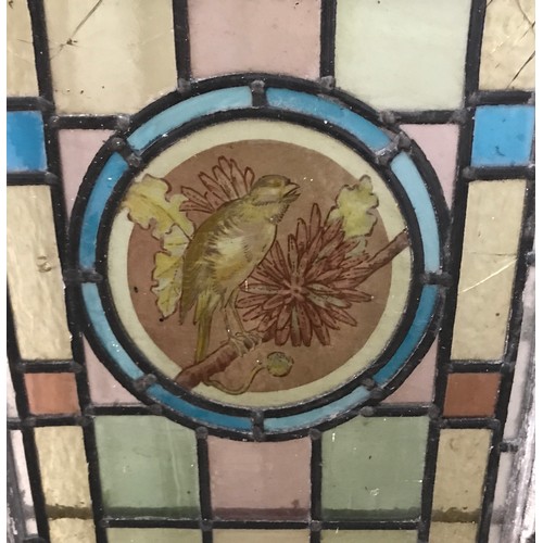 405 - A pair of stained-glass panels depicting a bird to the central pane. Full size 127 x 42cm.