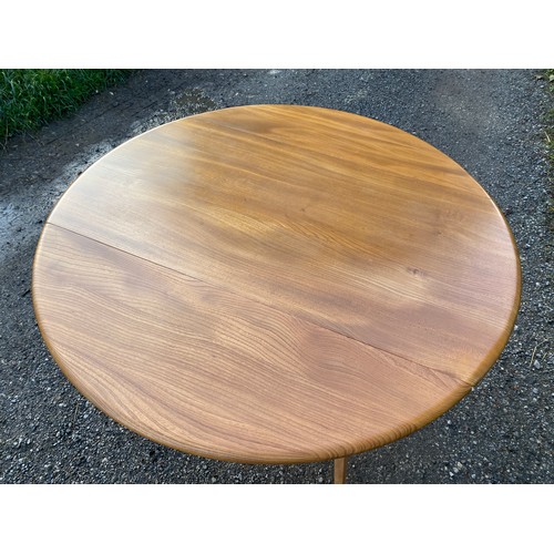 122 - Ercol oval dining table with two drop leaves 125 x 113.5 x 71cm fully extended and 61.5 with leaves ... 