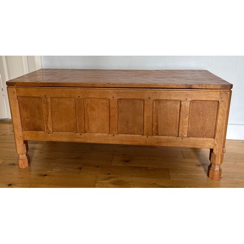 1162 - A Robert Mouseman Thompson panelled oak blanket box with hinged top on short octagonal baluster supp... 