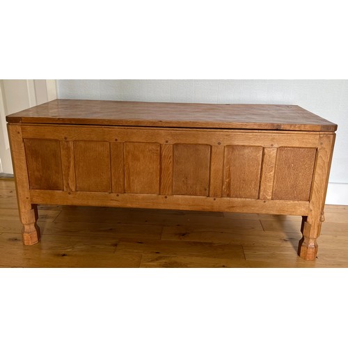 1162 - A Robert Mouseman Thompson panelled oak blanket box with hinged top on short octagonal baluster supp... 