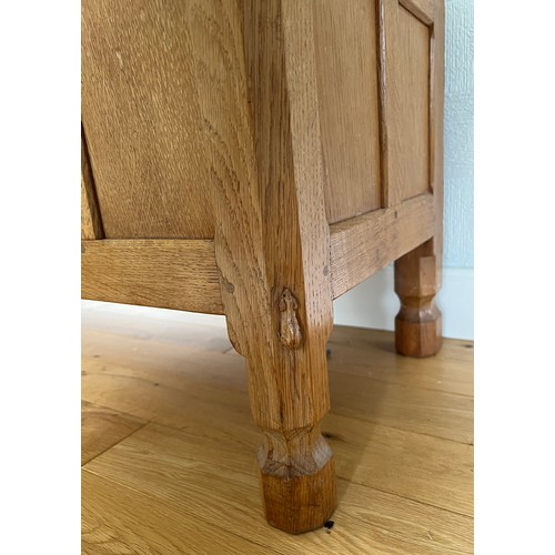 1162 - A Robert Mouseman Thompson panelled oak blanket box with hinged top on short octagonal baluster supp... 