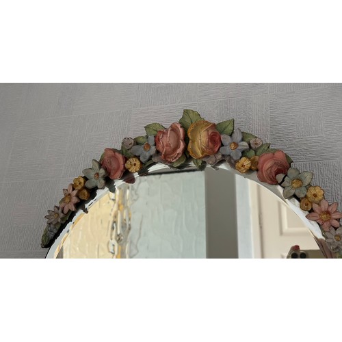 1144 - Floral decorated bevel edged wall mirror. 37cm.