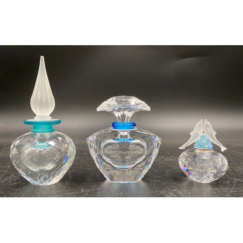 408 - Three Swarovski crystal perfume bottles with stoppers one with dolphins modelled to the stopper, tal... 