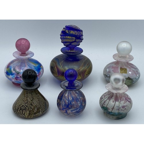 409 - Five Isle of Wight perfume bottles with stoppers together with another unlabelled possibly Isle of W... 