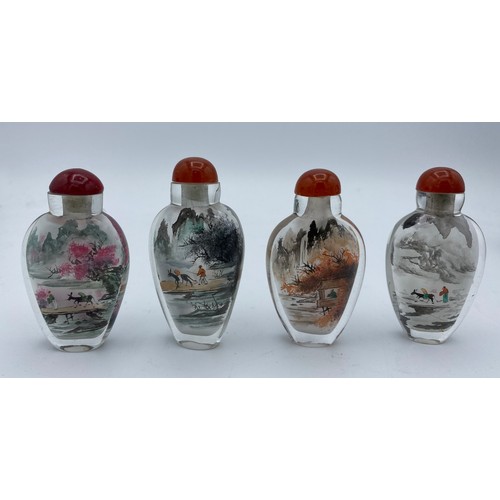 406 - Four Chinese painted perfume bottles in case depicting figures throughout the four seasons.