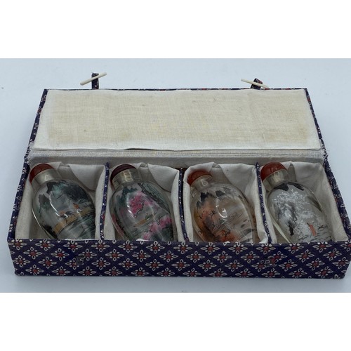 406 - Four Chinese painted perfume bottles in case depicting figures throughout the four seasons.